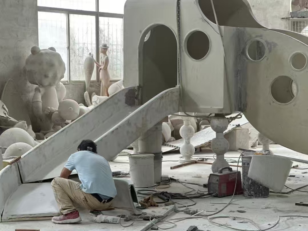 Fiberglass display structure being sanded in the workshop