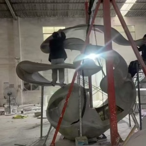 Large sculpture assembly inside the fabrication workshop