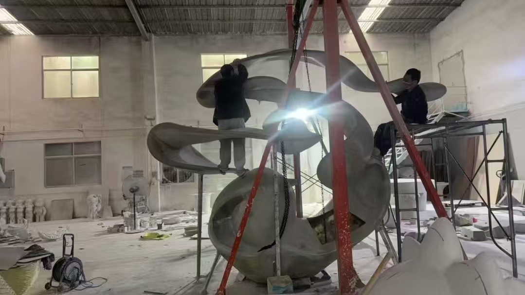 Large sculpture assembly inside the fabrication workshop