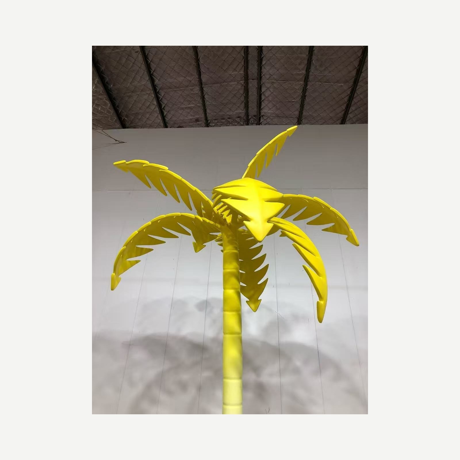 Detail view of the same yellow palm tree display prop