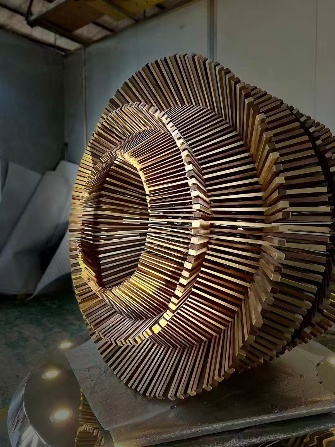 Layer spacing and bronze-tone finish detail on the same ring sculpture