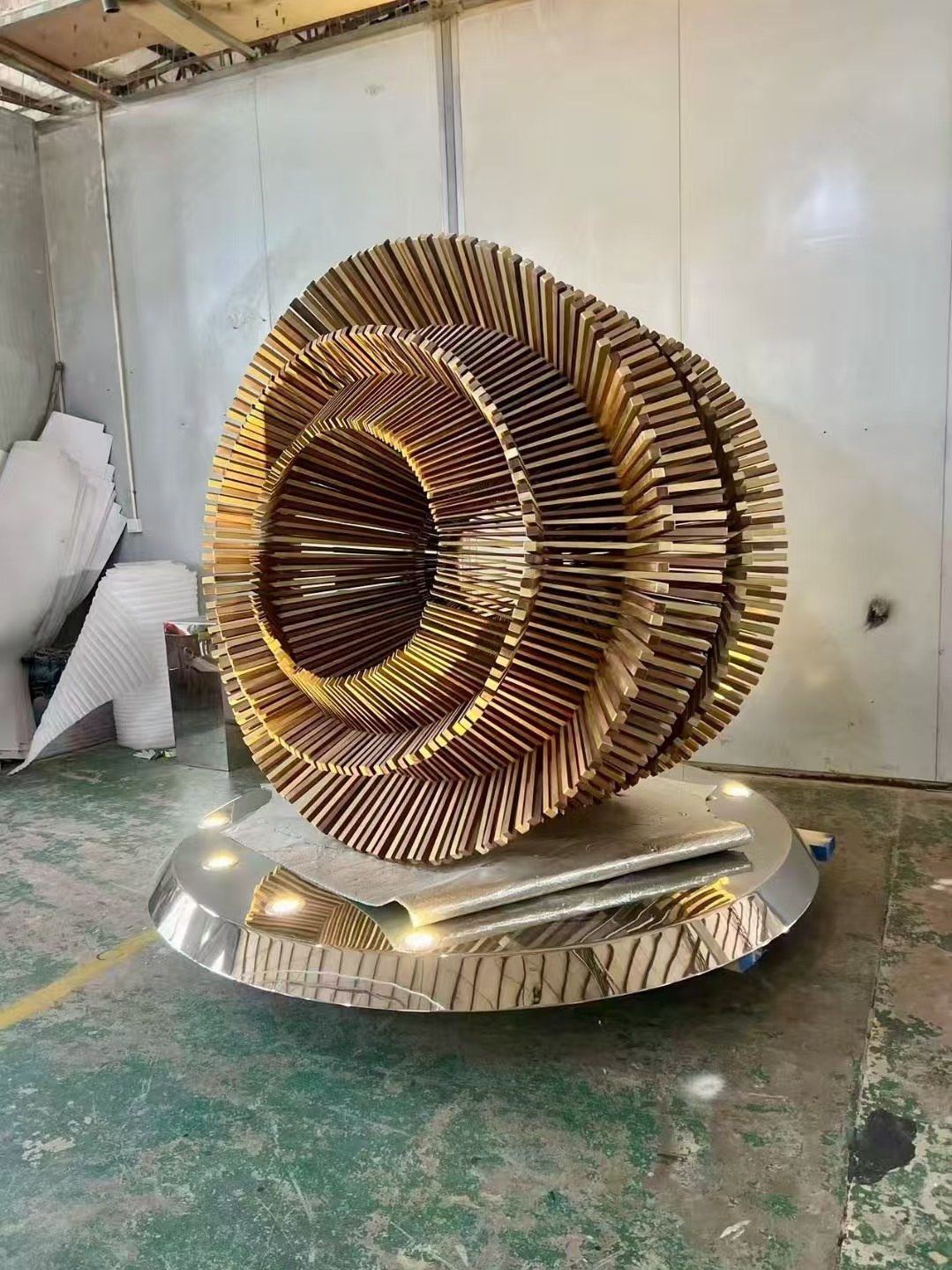 Second workshop view of the same completed layered ring sculpture