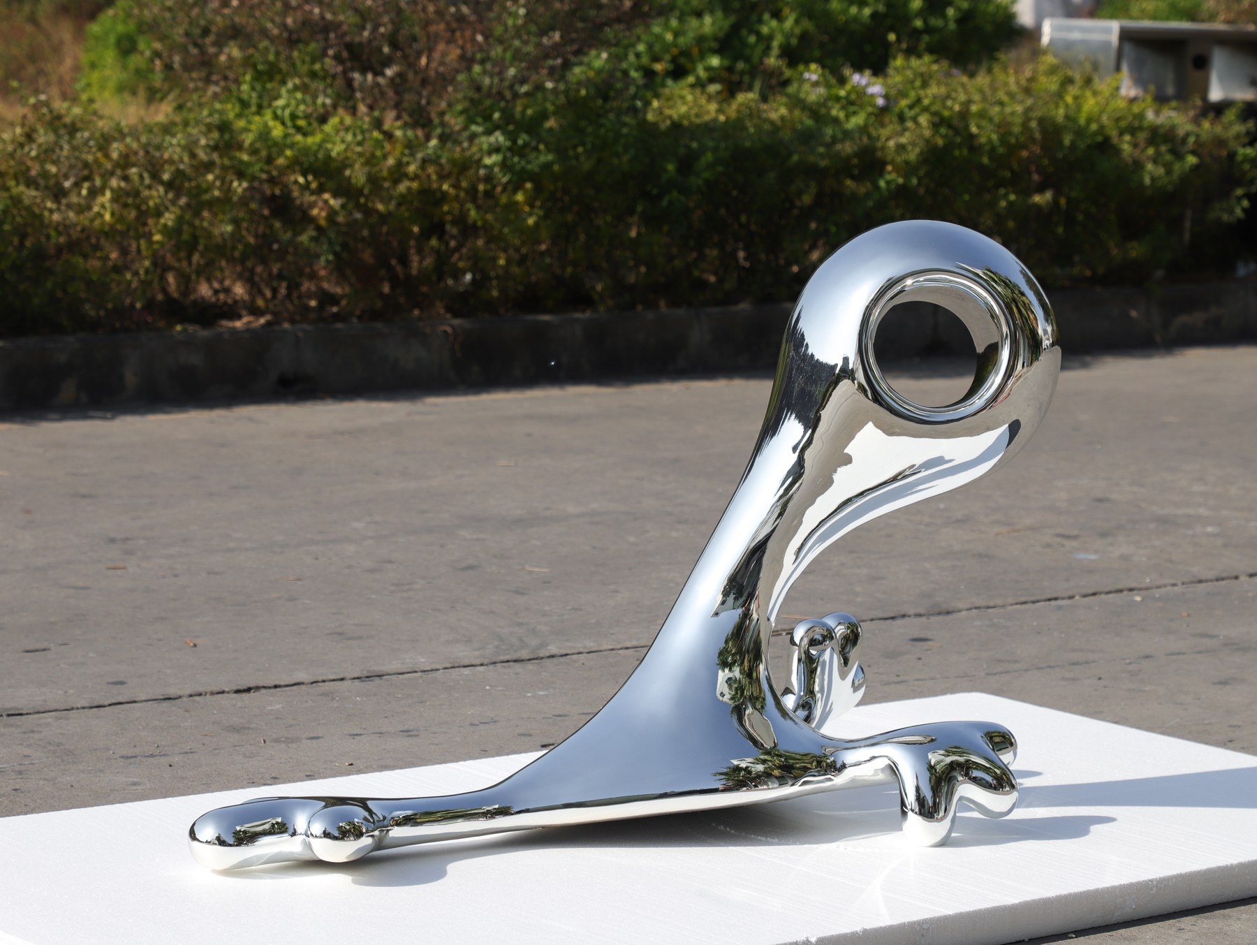 Completed chrome-finish organic display sculpture front three-quarter view
