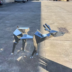 Side view of the same faceted mirror stainless steel deer sculpture