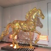 Gold openwork stainless steel horse sculpture in workshop finish inspection