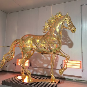 Gold openwork stainless steel horse sculpture in workshop finish inspection