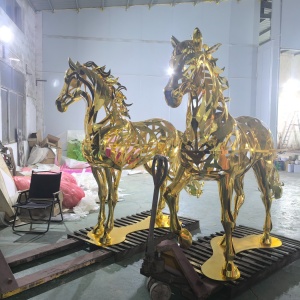Two completed gold openwork horse sculptures from the same fabrication project