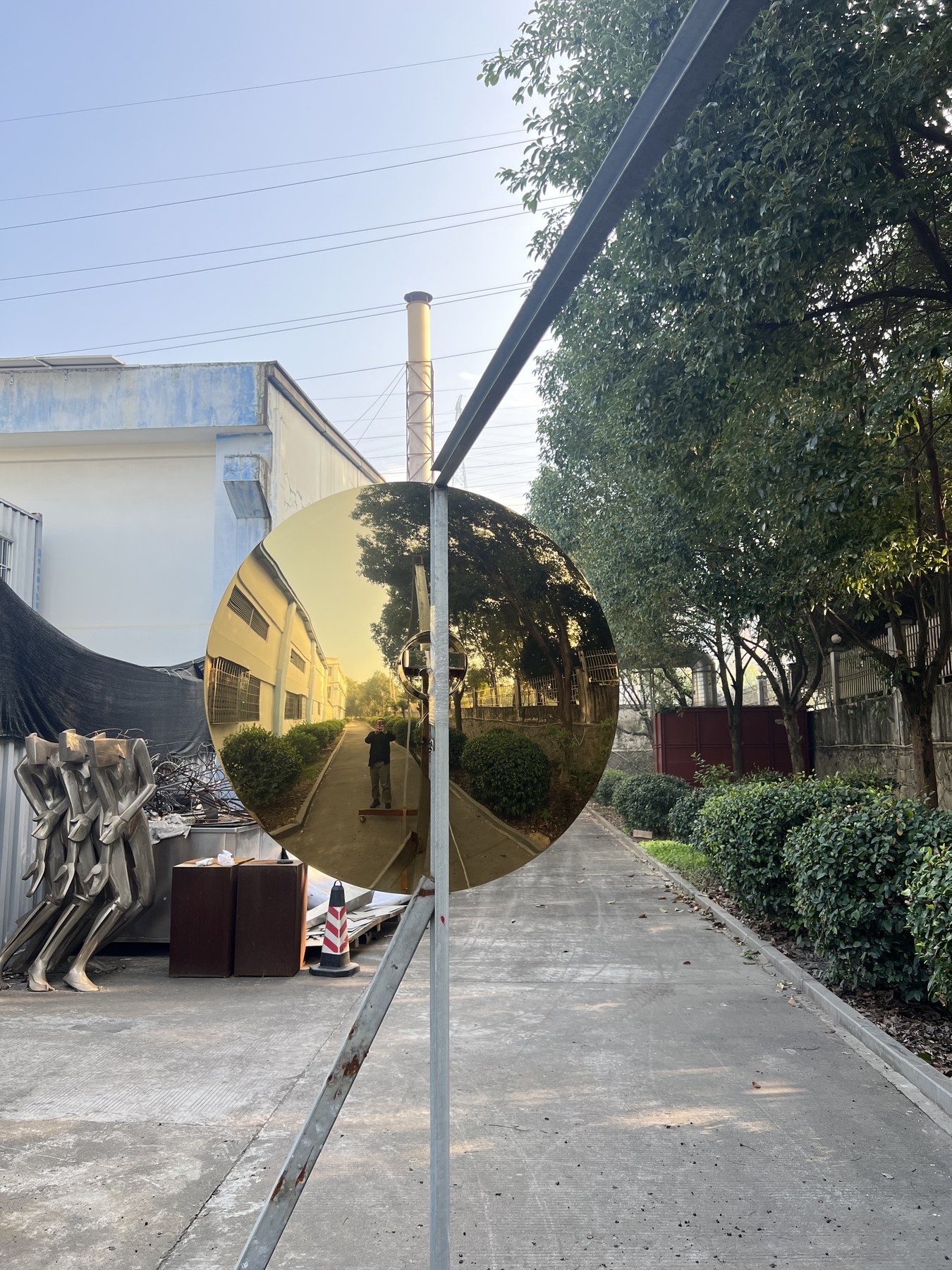 Second view of the same golden mirror stainless steel disc sculpture