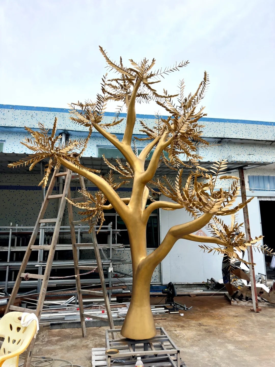 Completed golden stainless steel tree sculpture in the workshop