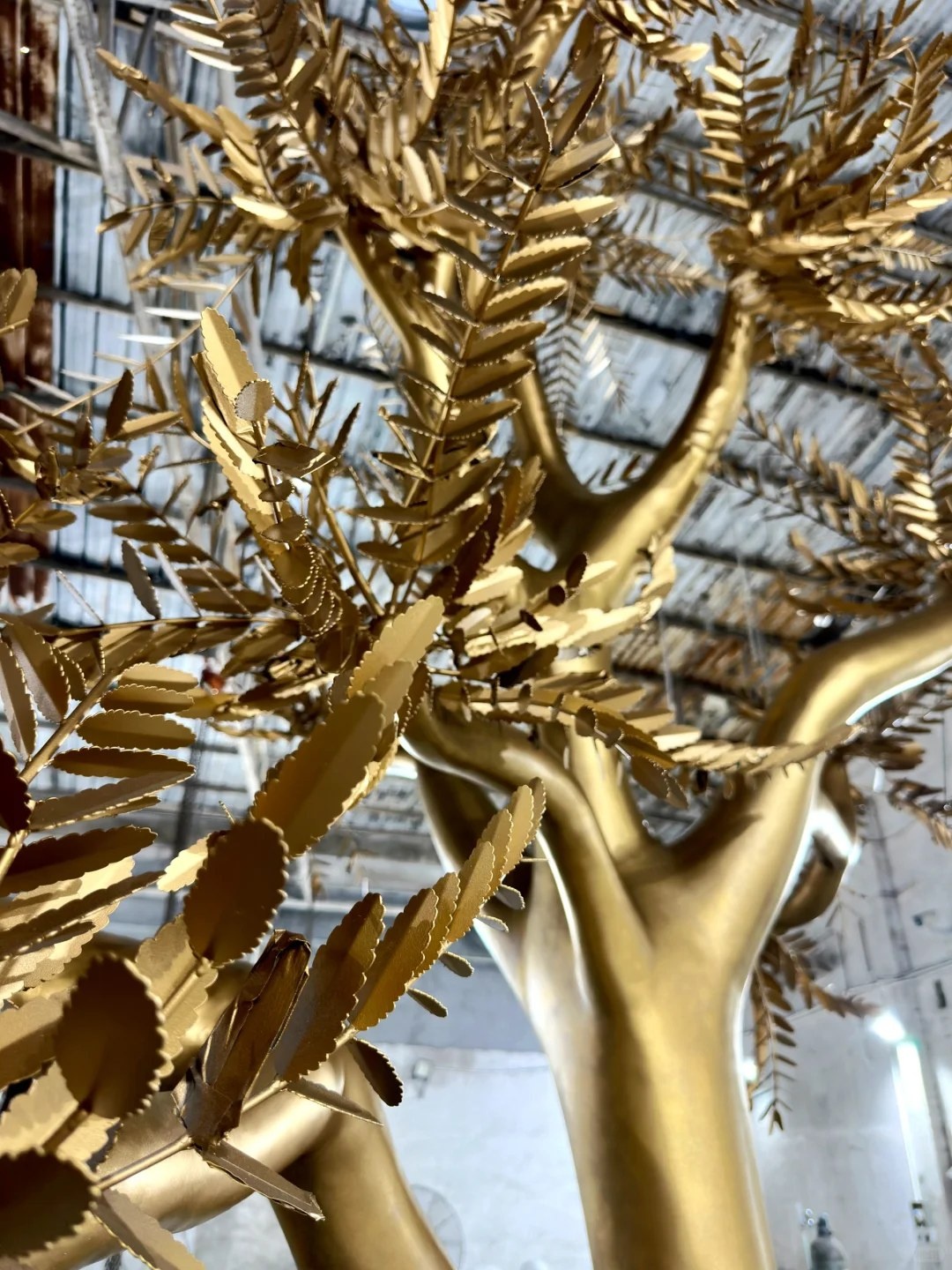 Second leaf and branch finish detail on the same golden tree sculpture