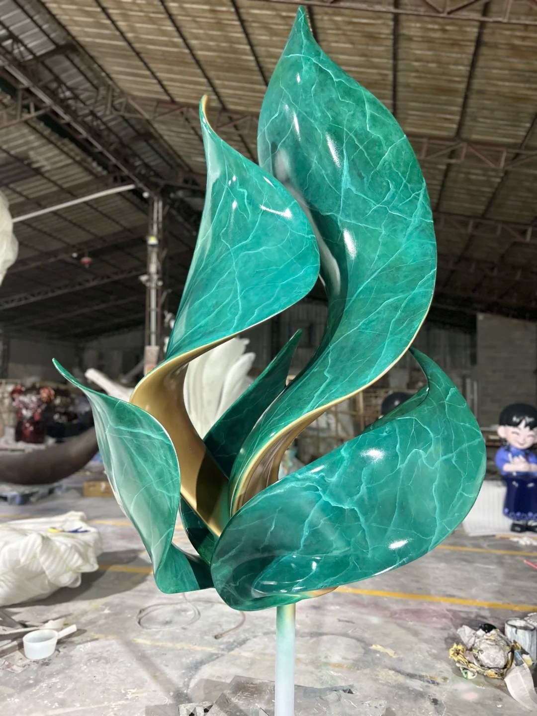 Front workshop completion view of the same green patina leaf sculpture