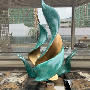 Second landscape setting view of the same green and bronze leaf sculpture