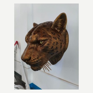 Opposite side angle of the same leopard head sculpture