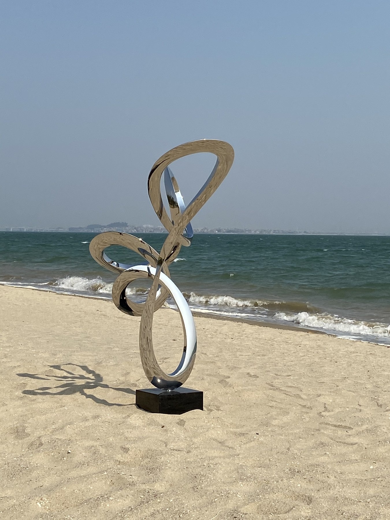 Rear view of the same mirror stainless steel loop sculpture