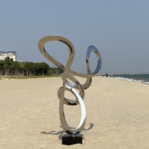 Side view of the same stainless steel loop sculpture