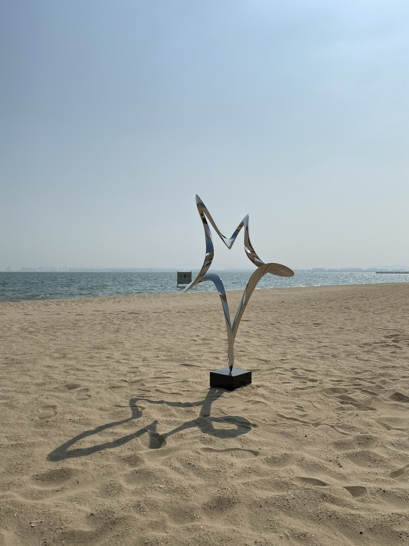 Second view of the same mirror stainless steel ribbon sculpture