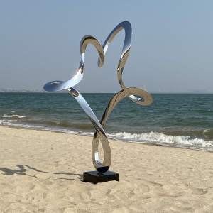 Front angle of the same reflective ribbon sculpture outdoors