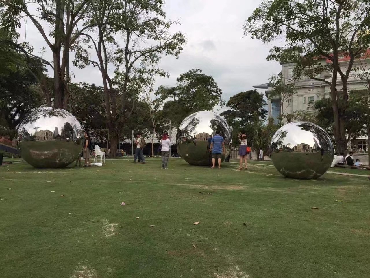 Installed mirror stainless steel sphere sculptures in an outdoor landscape project