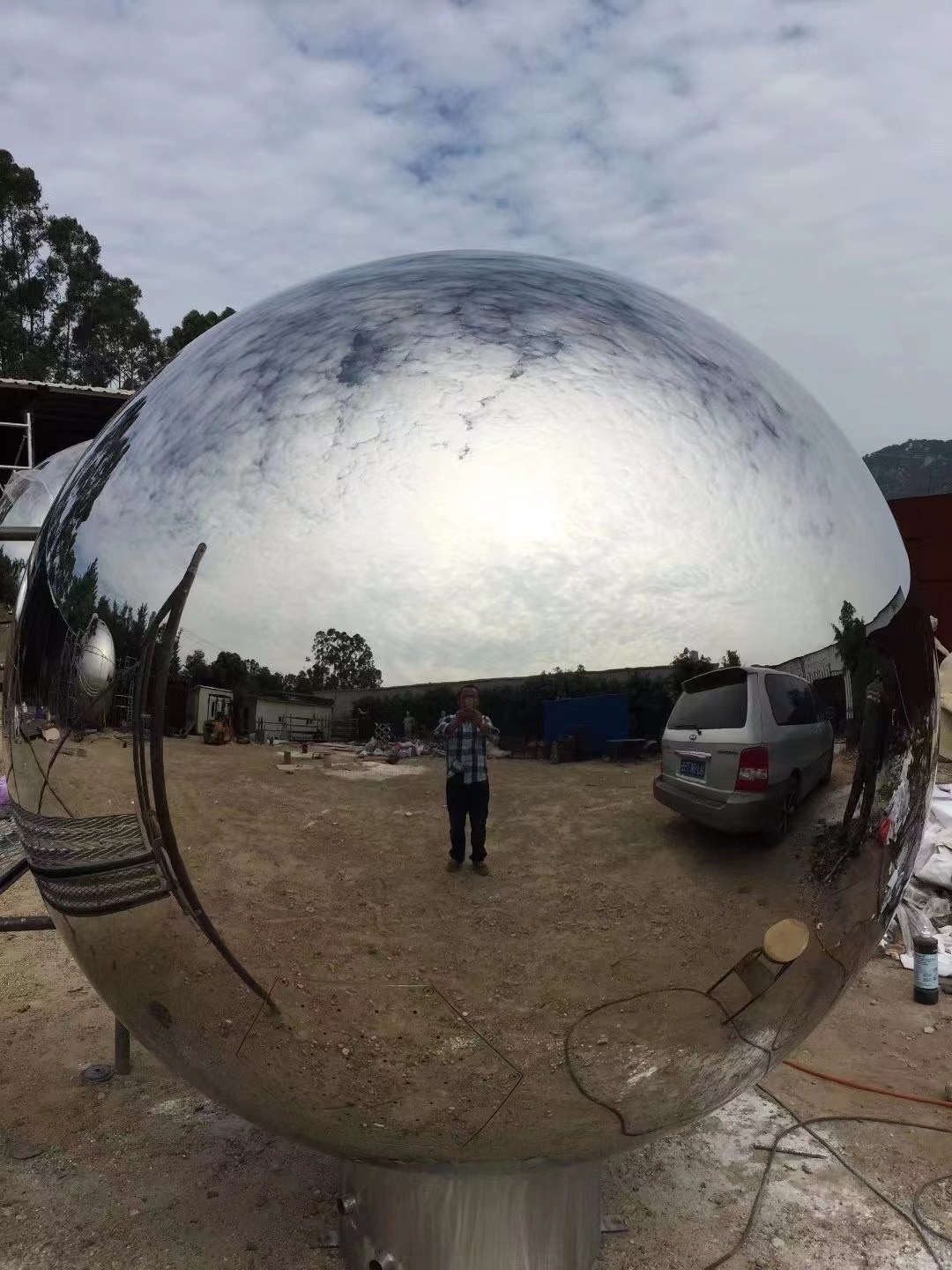 Mirror stainless steel sphere surface and reflection detail