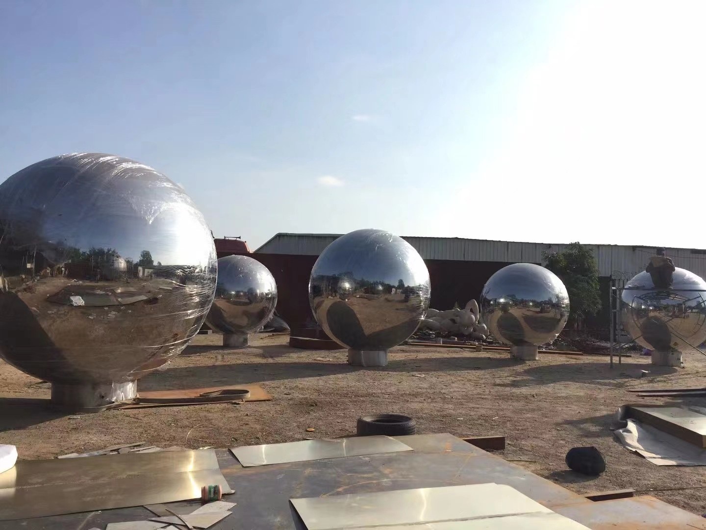 Multiple mirror stainless steel spheres from the same outdoor project