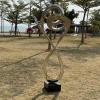 Installed mirror stainless steel spiral sculpture in a landscape setting