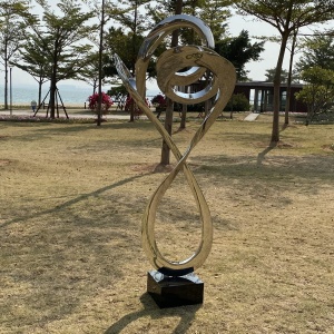 Installed mirror stainless steel spiral sculpture in a landscape setting