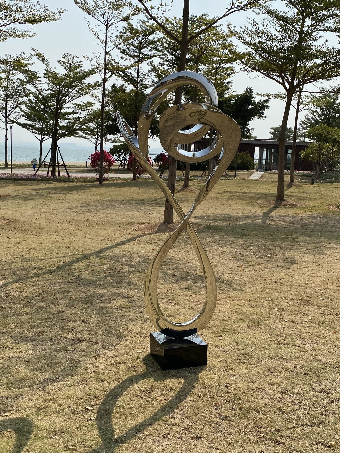 Installed mirror stainless steel spiral sculpture in a landscape setting