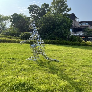 Installed openwork stainless steel kangaroo sculpture in a landscape setting