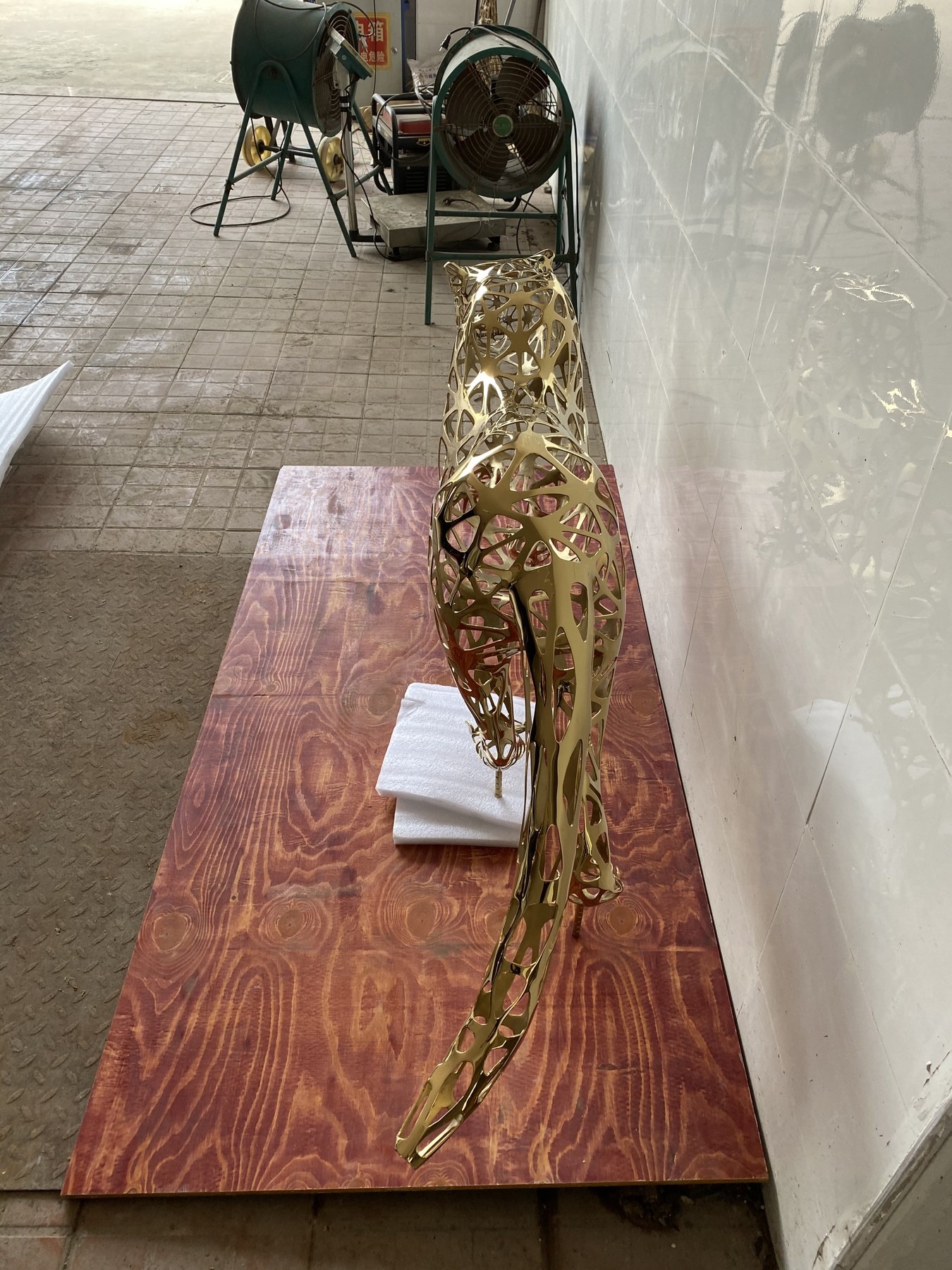 Rear and side view of the same openwork leopard sculpture