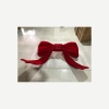Completed oversized red bow display prop in the workshop