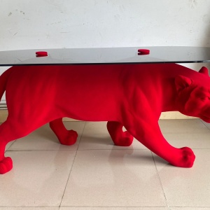 Red flocked panther sculptural display table front three-quarter view