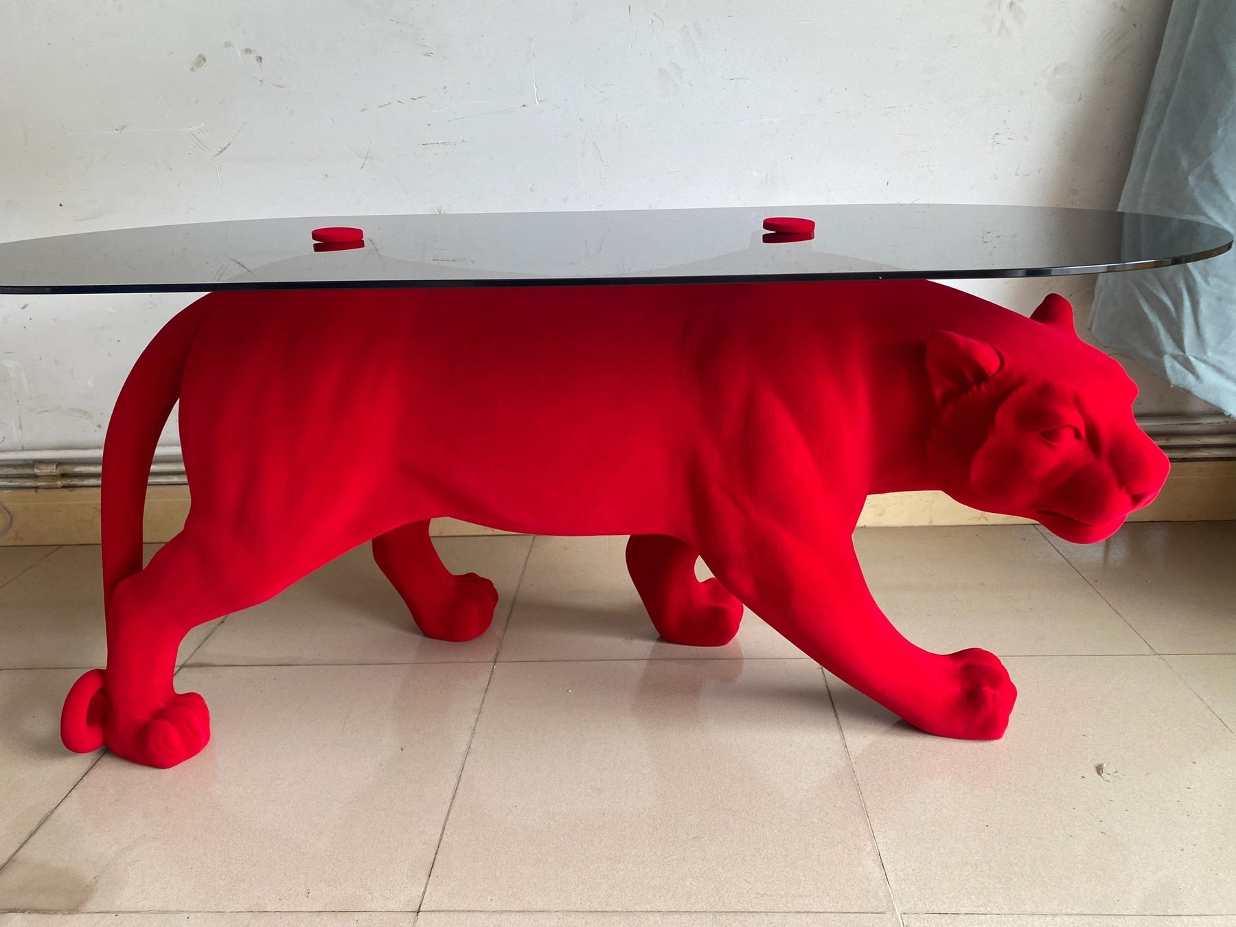 Red flocked panther sculptural display table front three-quarter view