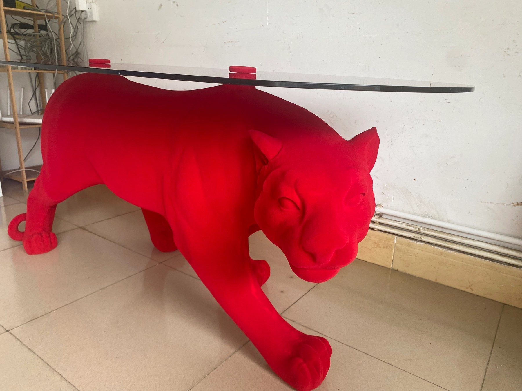 Side view of the same red flocked panther display table