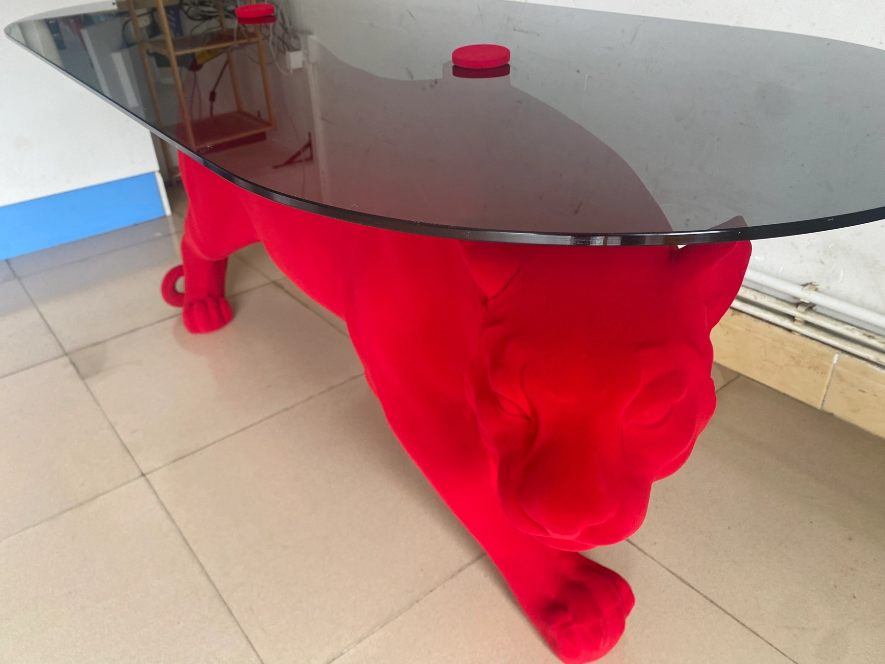 Flocked surface and glass-top detail on the same panther table