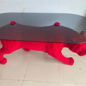 Rear three-quarter view of the same red flocked panther sculptural table