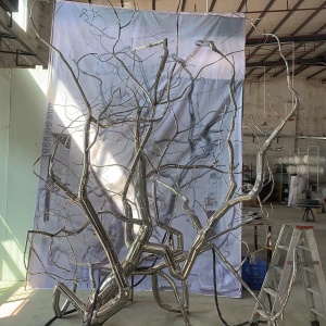 Workshop staging view of the same stainless steel branch sculpture