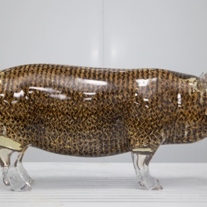 Rear three-quarter view of the same transparent pig display sculpture