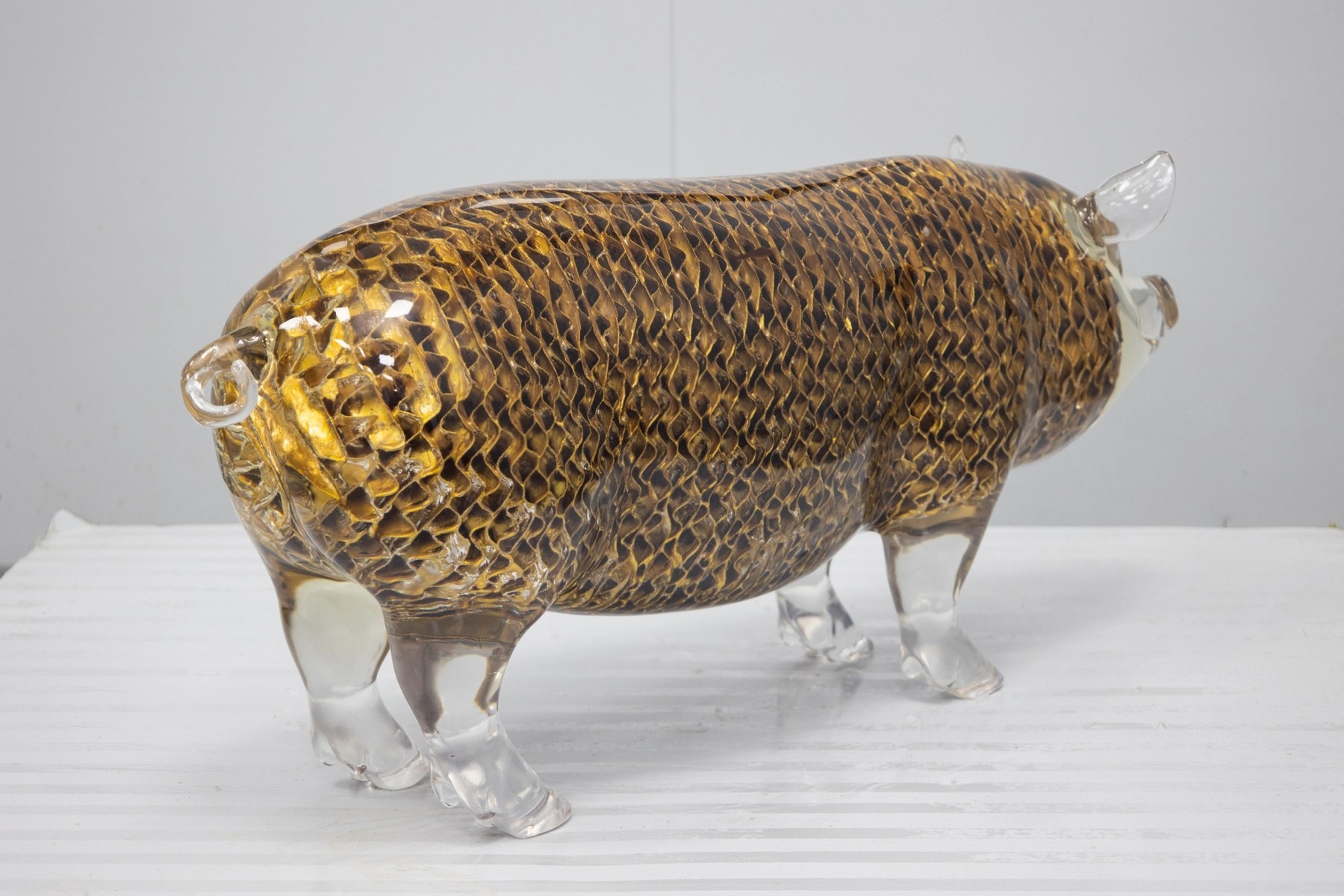 Full view of the same transparent openwork pig sculpture