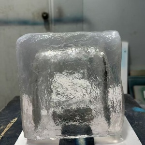 Transparent resin ice cube prop showing surface texture and optical clarity