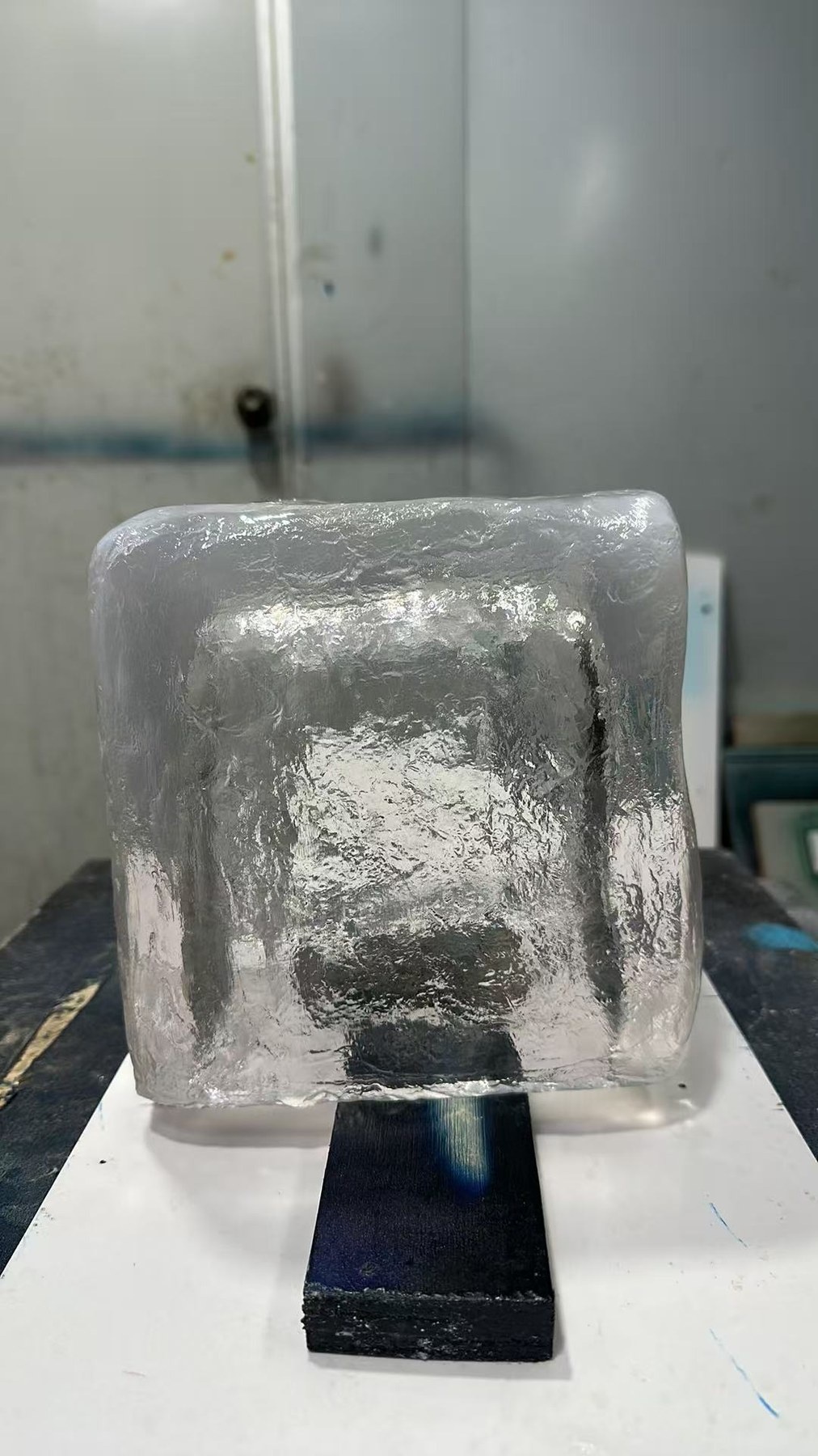 Transparent resin ice cube prop showing surface texture and optical clarity