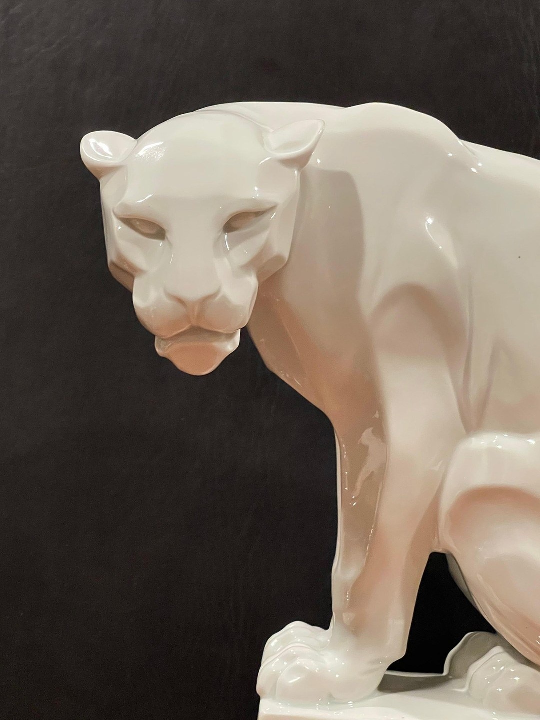 Rear three-quarter view of the same white panther sculpture