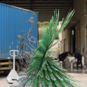 Side view of the metal peacock sculpture during workshop fabrication