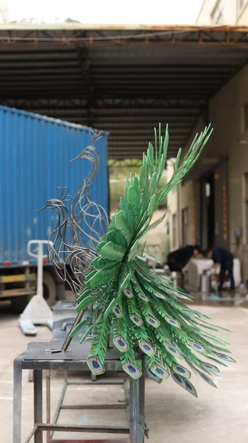 Side view of the metal peacock sculpture during workshop fabrication