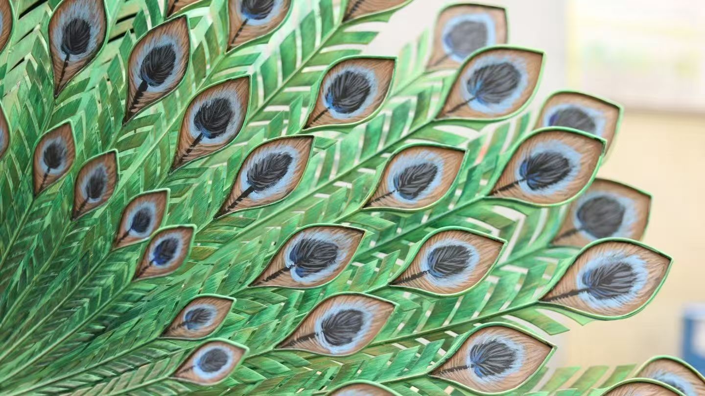 Painted metal peacock tail feather detail and surface finish